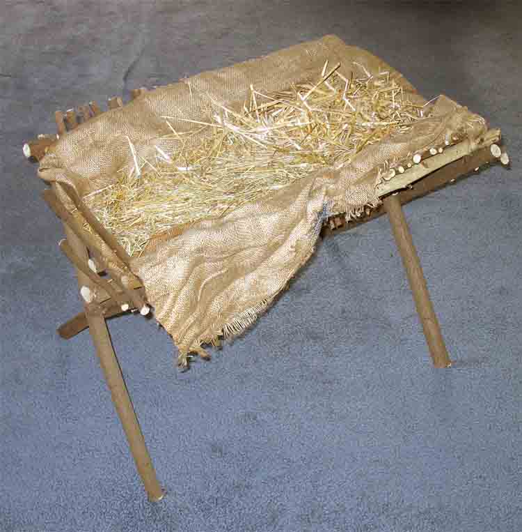 The manger with cover and straw, ready for the baby.